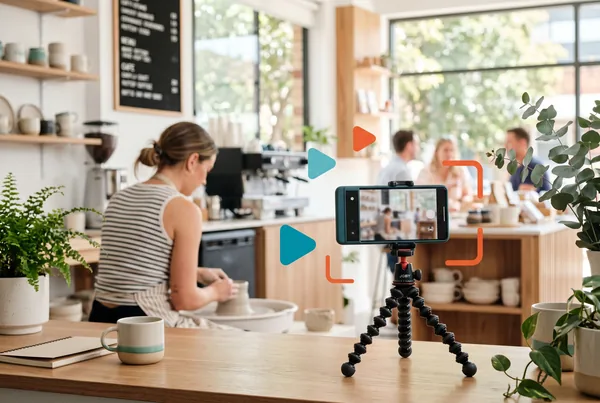 A tradesperson filming a finished job on a phone, with the same clip shown as a captioned short on the screen beside them